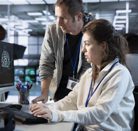 worker-requesting-help-from-senior-engineer-fix-error-high-tech-data-center-min